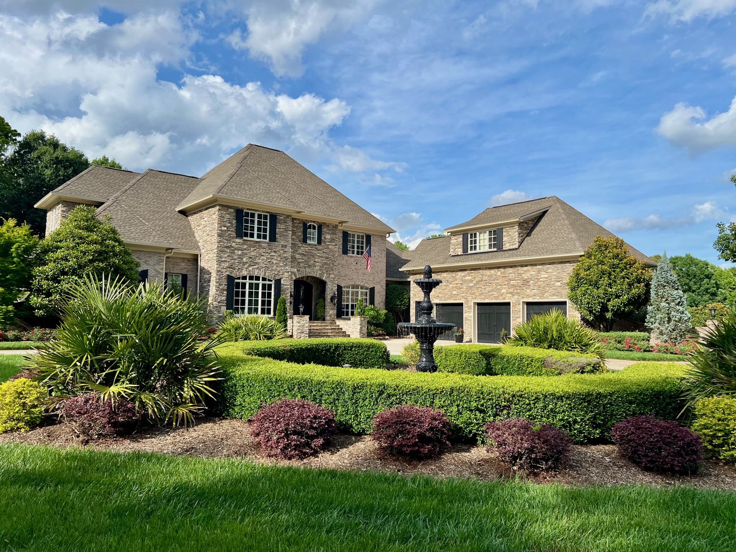 Brick estate with formal fountain garden