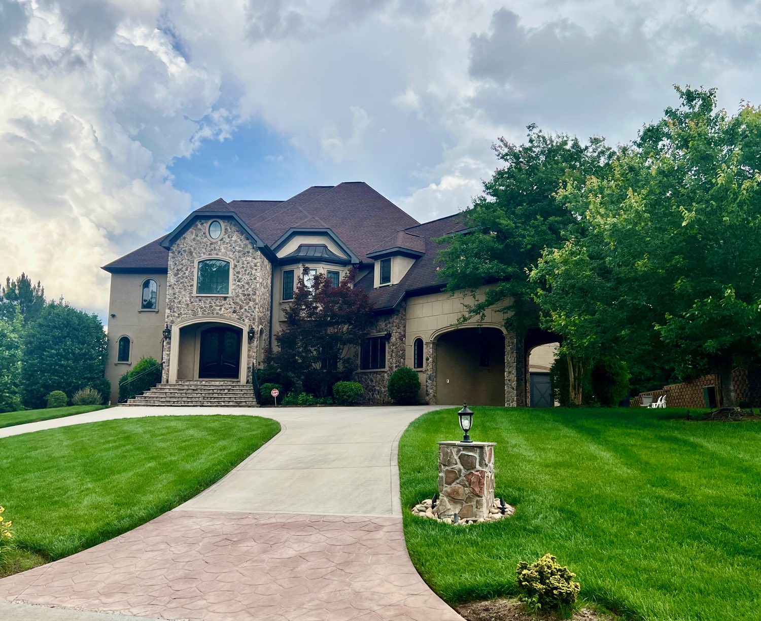 Stone and stucco custom home with circular drive