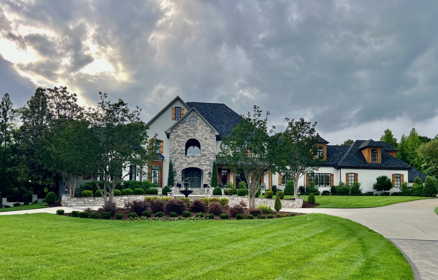 Stone manor home at dusk